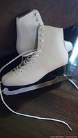 Both skates side view showing blades and laces