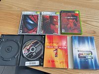 Group shot of all five Xbox game cases with discs and manuals