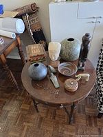 Overall view of all eleven African decor pieces on round table