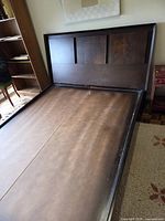 Full view of wooden platform bed frame with headboard