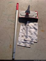 Unboxed Duop dust mop showing handle, mop head, and branded pads