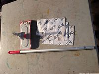 Unboxed Duop dust mop showing microfiber pad, mop head and handle