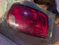Tail light assembly wrapped in plastic