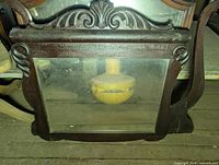 Rectangular carved wood mirror with scroll sides and top crest