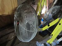 Two Dayton wall-mount fans on yellow extension brackets