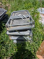 Stacked folding metal carts, handles folded flat
