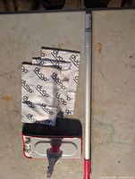 Mop handle, swivel head and microfiber pads from one kit displayed on table