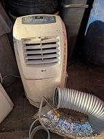 Front view of LG portable air conditioner with hose