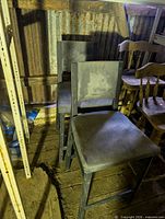 Two black painted wood stools with square backs and footrests