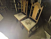 Two high-back carved side chairs with floral needlepoint seats