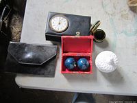 Overall view of purse, clock box, compact, Baoding balls in case, white jar