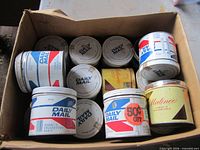 Box containing twelve assorted tobacco tins