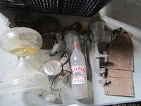 Overview of compote, grinder, Sun-Rise bottle, metal mice, plaque, hinges