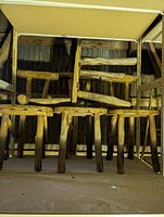 Stacked rustic log stools on shelving