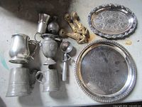 Group of pewter vessels, two silver-plated trays, brass hardware and metal scoop