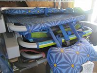 Stacked blue patterned foldable beach chairs showing frame, fabric and straps