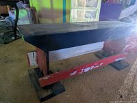 side view of wooden bench showing painted supports