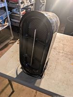 Front view of black Bionaire tower air purifier showing intake grille and power cord