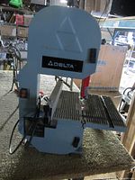 Overall view of Delta bench top band saw showing housing, table and blade guard