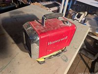 Honeywell red metal heater with handle on tabletop