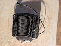 Top view of black slatted electric insect killer showing overall design and attached cord