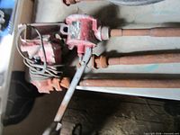 Both pumps on workbench, showing lever, motor housings and suction pipes