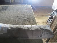 Cardboard box with Zinus branding on carpeted floor