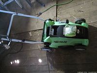 Top view of mower showing deck, handle, battery compartment