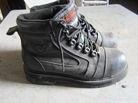 Left side view showing overall construction, leather, steel toe and logo