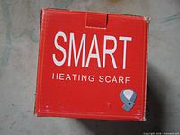 Front of red retail box labeled Smart Heating Scarf