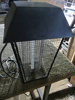 Front view of one electric bug killer showing metal cage and power cord