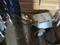 Full view of tile stripper showing wheels, handle, and body