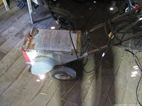 Overall view of floor tile stripper showing wheels, handle, and body