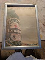 Framed Heineken advertising sign