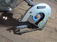 Hitachi CC14 chop saw showing blade guard, abrasive disc and base