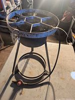 Full view of stand-up propane cooker on table