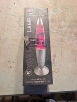 Front of boxed wax motion lava lamp showing size and design