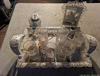 Ornate tray, lidded container, mirror, six glasses