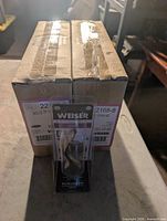 Two sealed boxes with blister-pack Weiser Trapani dummy lever in front