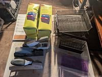 Tabletop view showing boxed desktop organizers, staplers, mesh trays and file sorter, purple tray