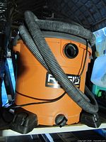Front view of Ridgid WD16400 vacuum with hose coiled