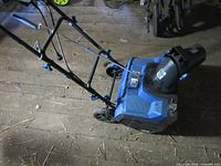 Overall view of Snow Joe blue electric snow thrower with folded handle