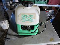 Front view of Spray Doc backpack sprayer showing tank, pump handle and wand