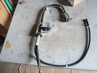 Full faucet with hose and mounting hardware visible