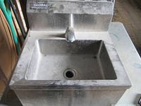 Front view of sink showing basin, faucet, backsplash