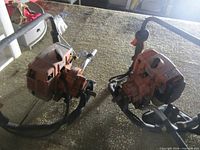 Two Stihl BT120C post drillers on tabletop