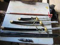 Overview of swords, scabbards and dagger on table