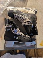Pair Bauer skates on table showing full condition