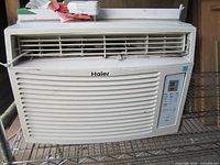 Front view showing Haier branding, grille, control panel
