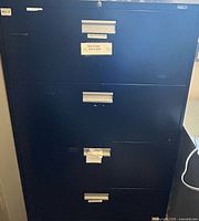 Front view showing all four drawers, pulls, label holders, and lock